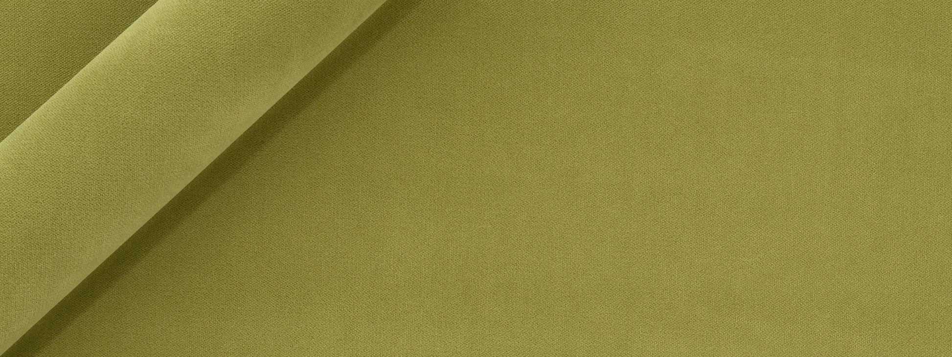 Apple green velvet upholstery fabric, folded with plush texture; close-up detail.