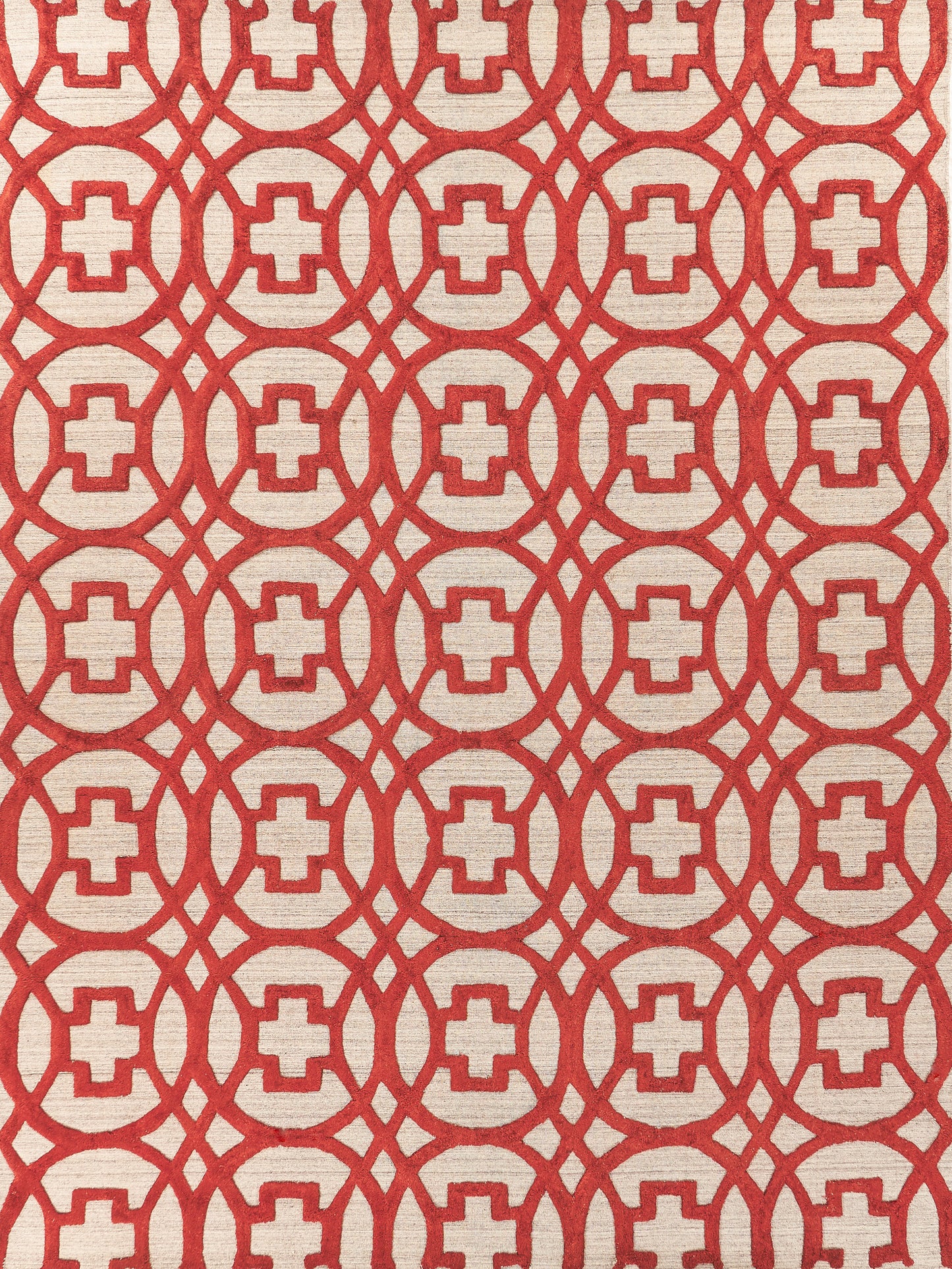 Cream rug with bold red geometric lattice of interconnected circles enclosing square centers; hand loomed indoor rug.