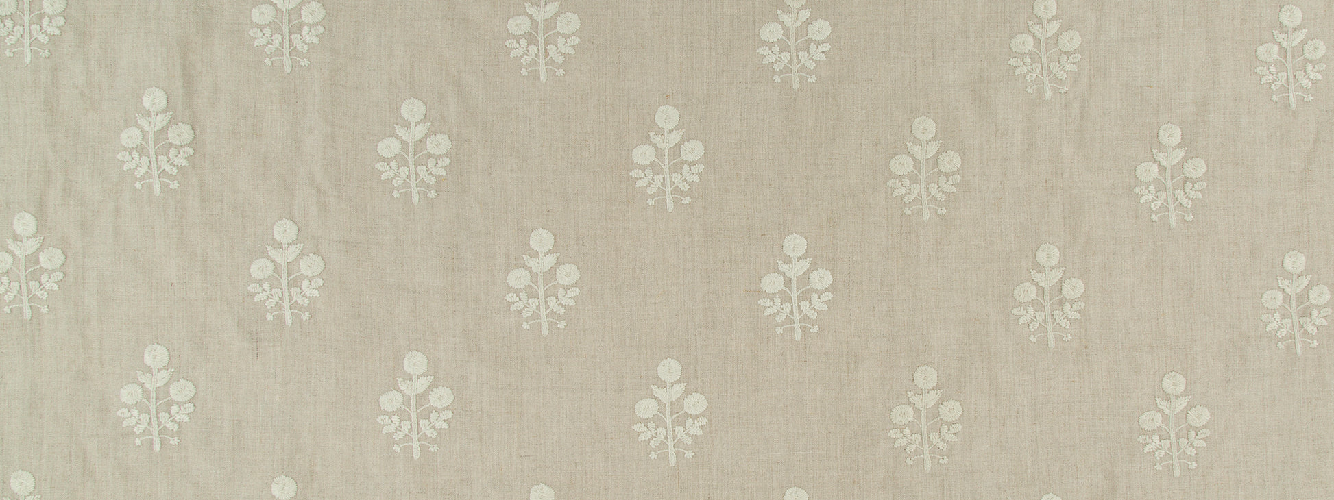 Beige linen-textured fabric with repeating white floral damask motifs; vintage upholstery or wallpaper use.
