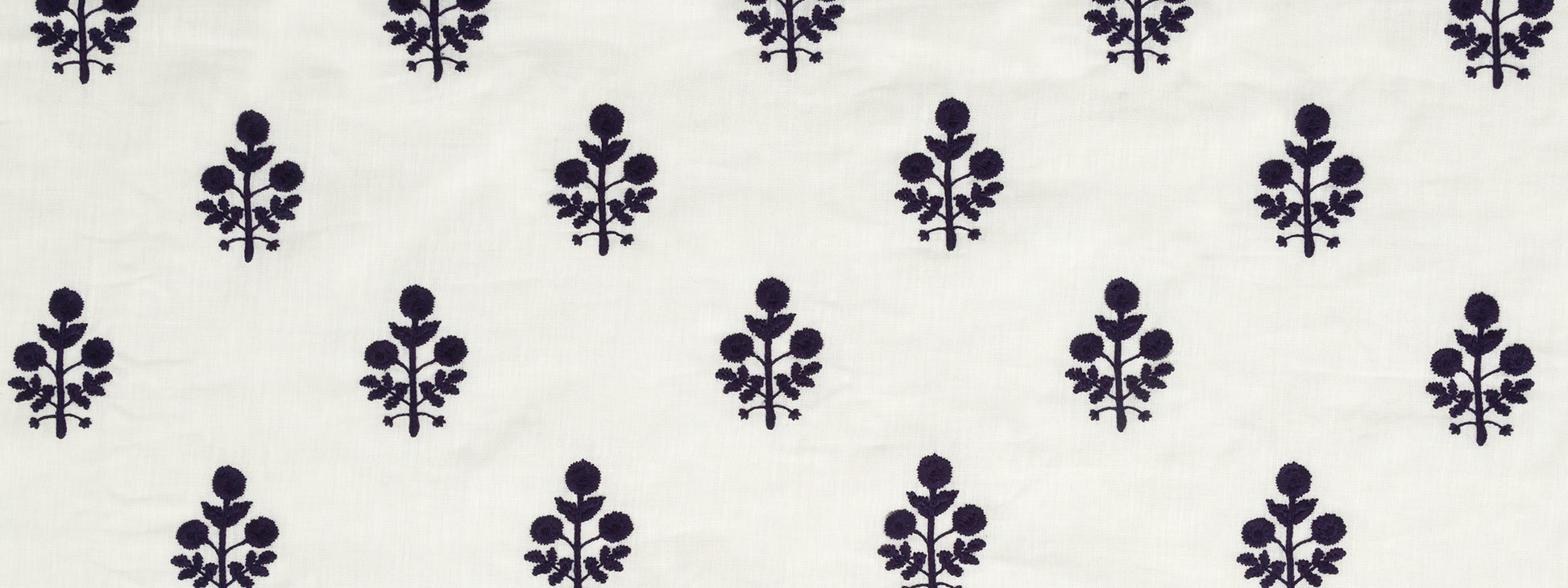Dark purple floral motifs repeating on navy background; small botanical pattern for fabric, bedding, or apparel.