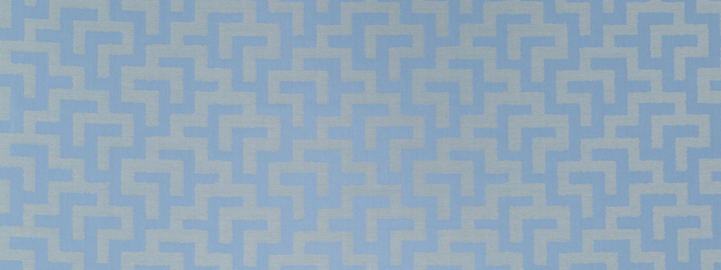 Blue geometric maze pattern in pale blue on solid blue chambray fabric; seamless repeating pattern.
