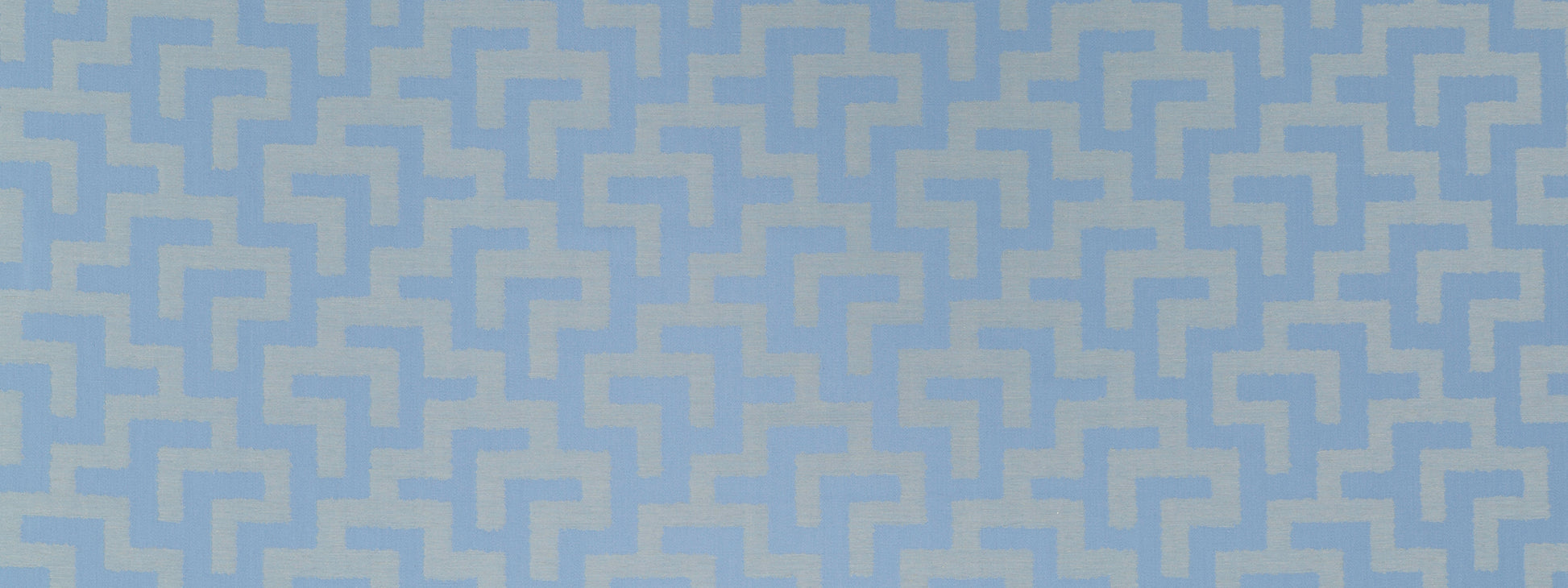 Blue geometric maze pattern in pale blue on solid blue chambray fabric; seamless repeating pattern.