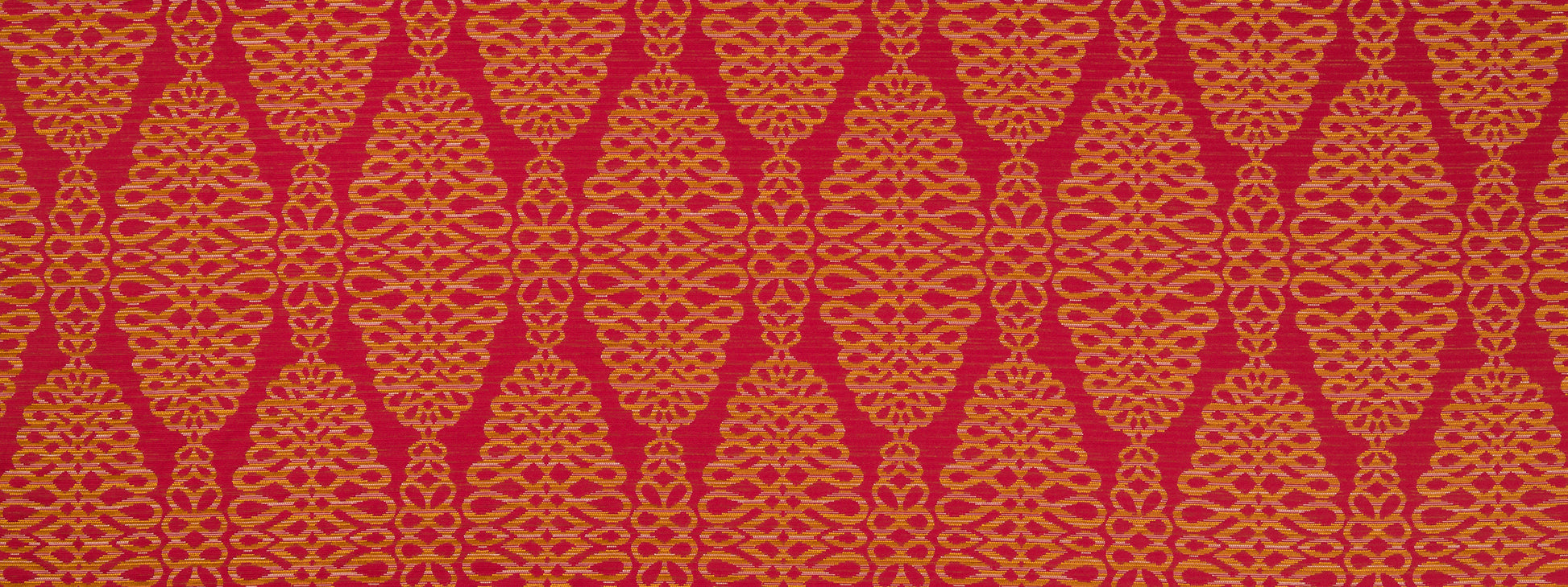 Red fabric with a gold ornate damask lattice pattern; decorative textile for upholstery or fashion.