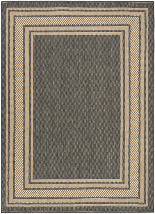Dark gray woven rug with tan nested rectangular borders; modern geometric, neutral tones for living room.