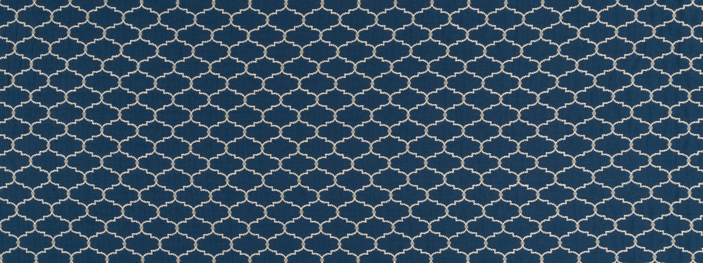 Dark blue upholstery fabric with a white interlocking quatrefoil lattice pattern.