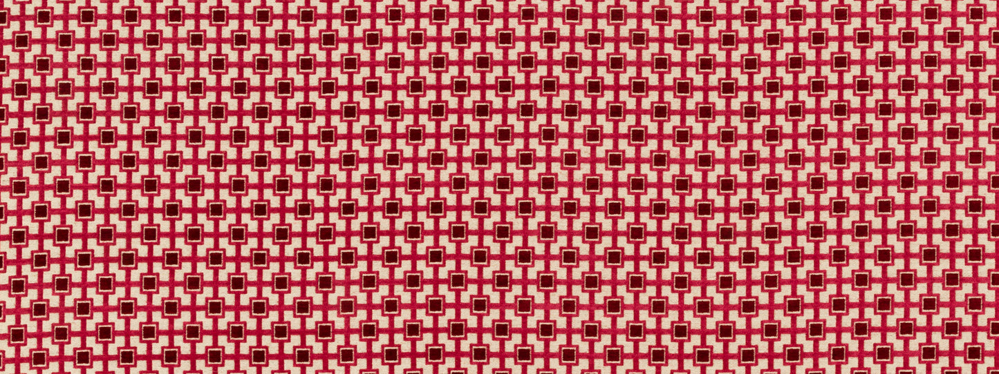 Red and white geometric lattice fabric pattern with small star-like squares; bold textile suitable for upholstery or crafts.