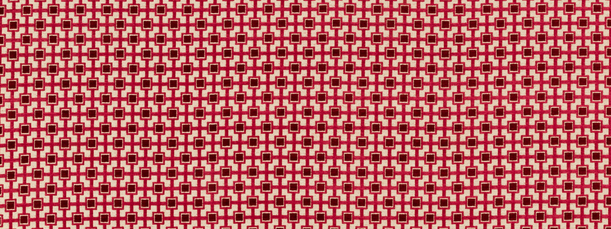 Red and white geometric lattice fabric pattern with small star-like squares; bold textile suitable for upholstery or crafts.