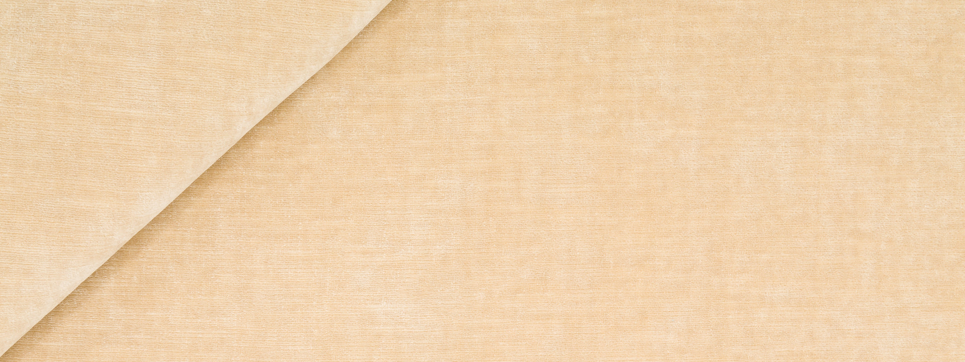 Beige velvet upholstery fabric with a diagonal fold, soft texture and natural look.