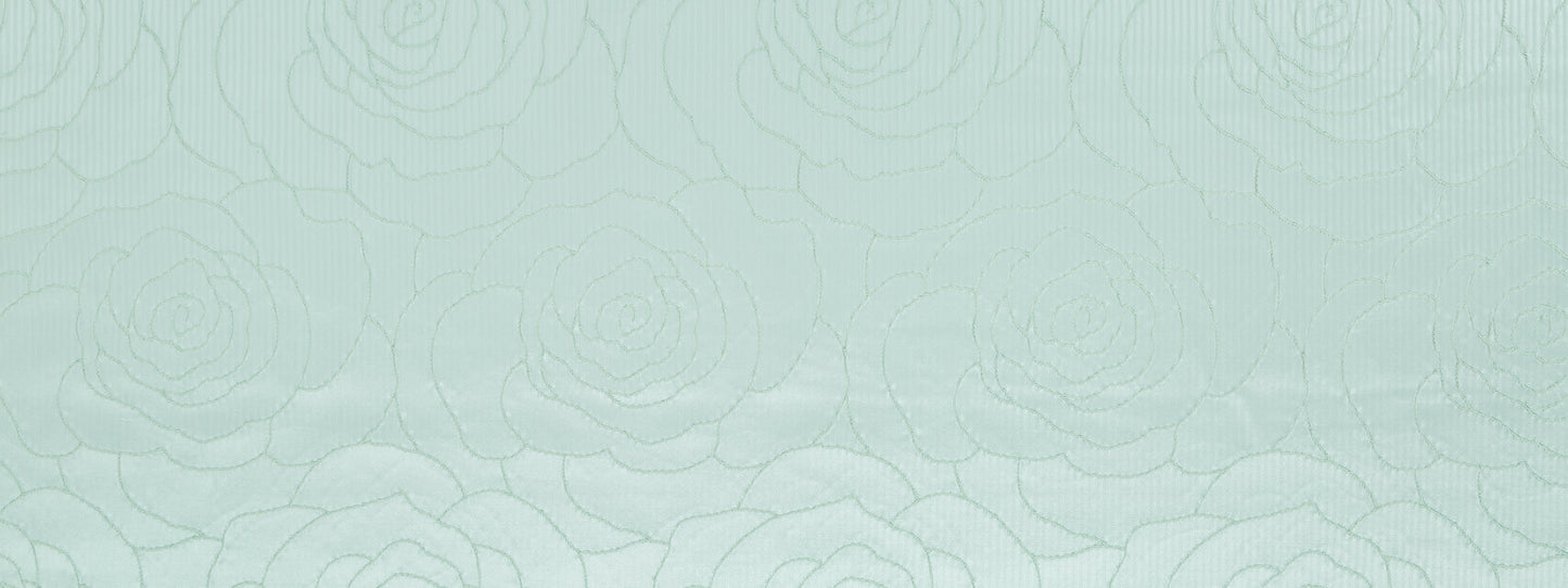 Light mint green fabric with subtle embossed camellia pattern and textured surface.