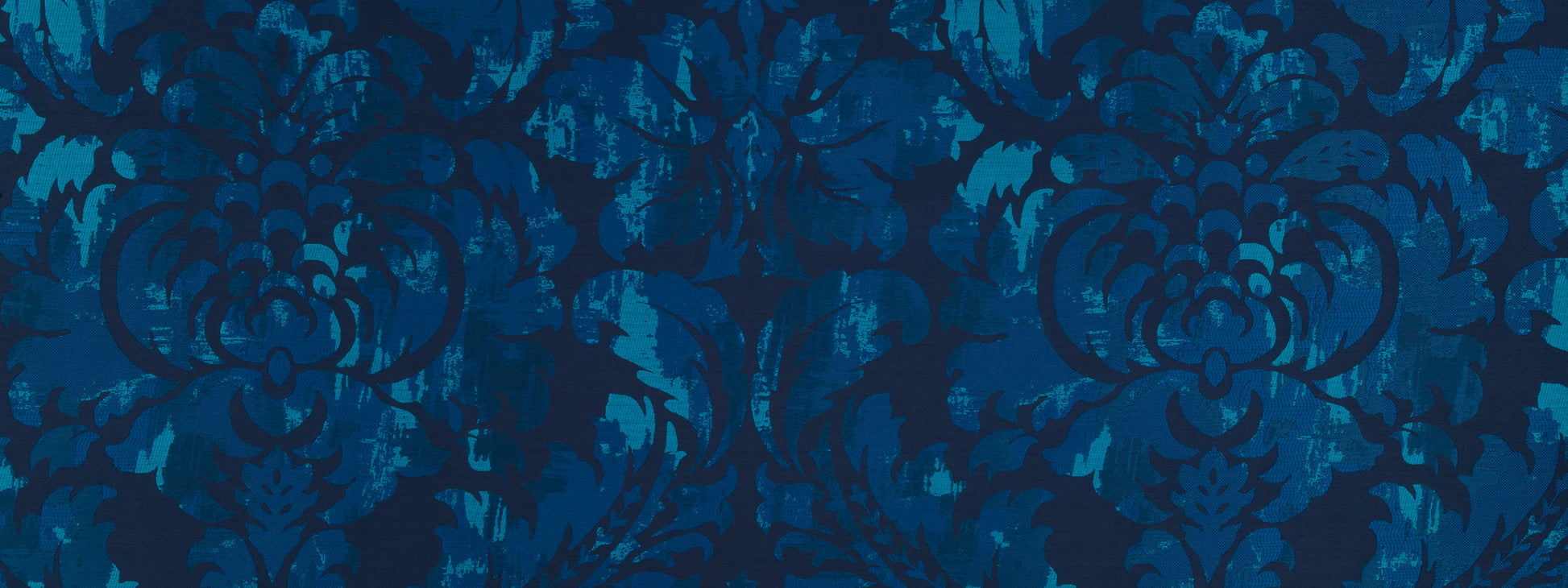 Blue damask pattern fabric with ornate, symmetrical floral motifs in deep navy and turquoise.
