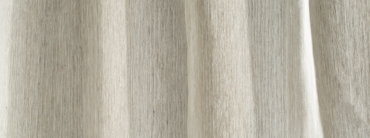 Close-up of light beige linen curtain fabric with vertical folds, drapery panel for window use.