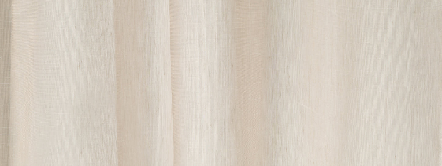 Cream-beige curtain fabric with soft vertical folds; neutral window drape for living spaces.