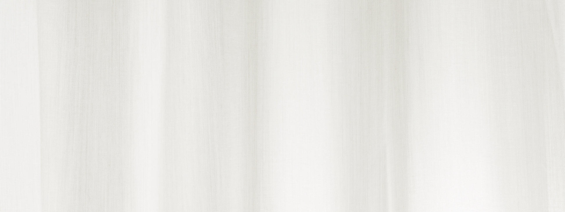 Soft white sheer curtain fabric with gentle vertical folds.