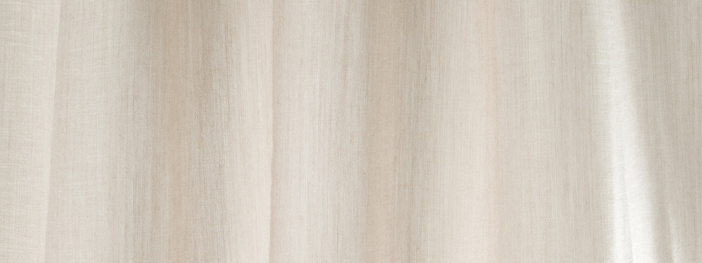 Beige wool-veil curtain fabric with soft vertical folds, neutral window drapes.