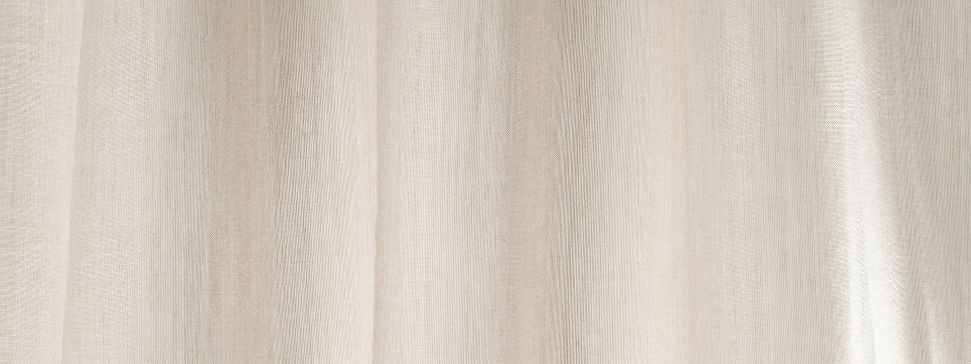 Beige wool-veil curtain fabric with soft vertical folds, neutral window drapes.