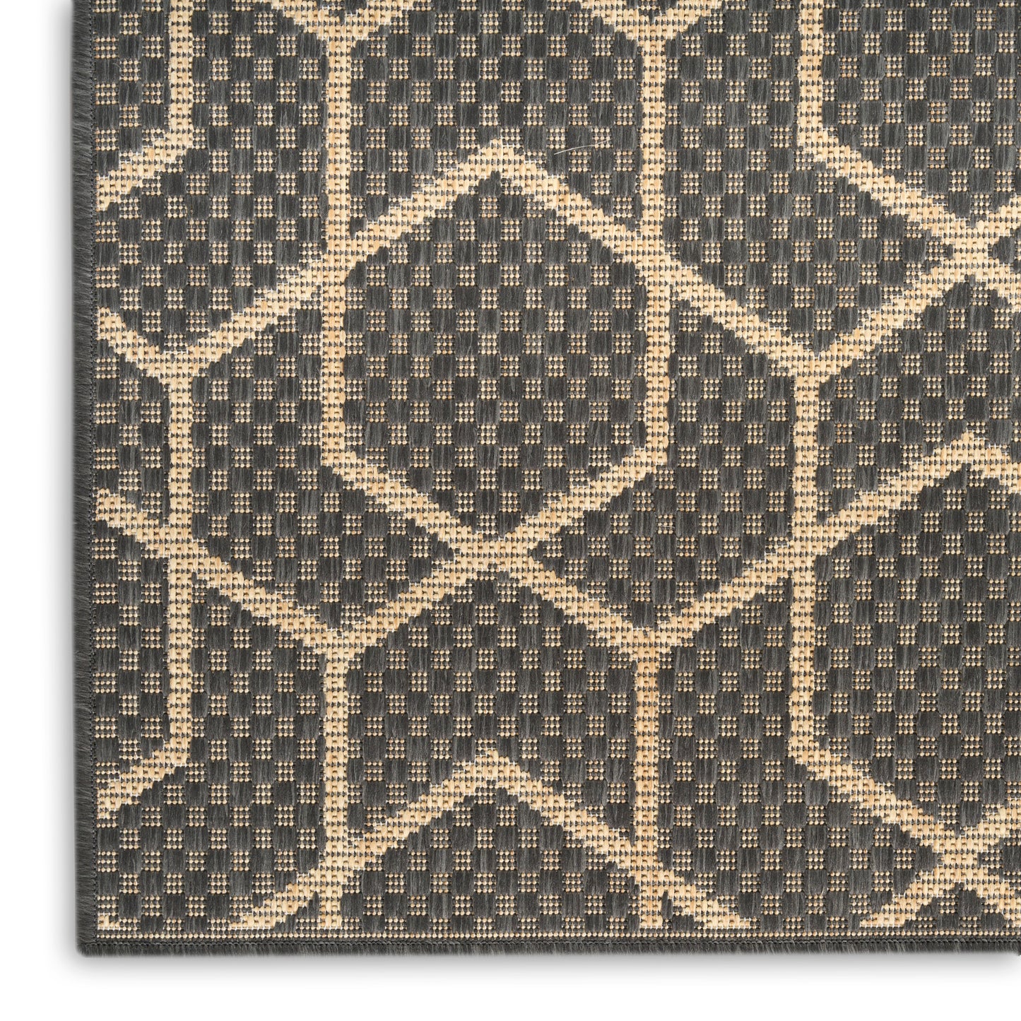 Charcoal gray woven rug with tan geometric lattice pattern and textured weave.