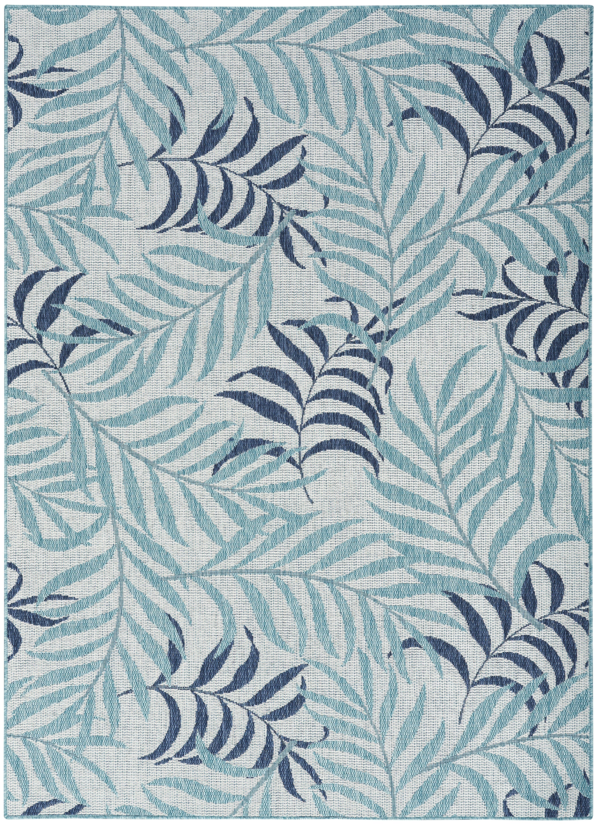 Teal & navy palm leaf patterned area rug on a light gray background.