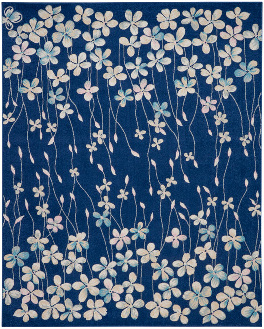 Blue floral rug with white and pastel blossoms on long trailing stems; modern decorative style.