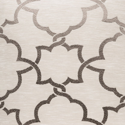 Beige textured pillow with a dark taupe interlocking quatrefoil trellis pattern.