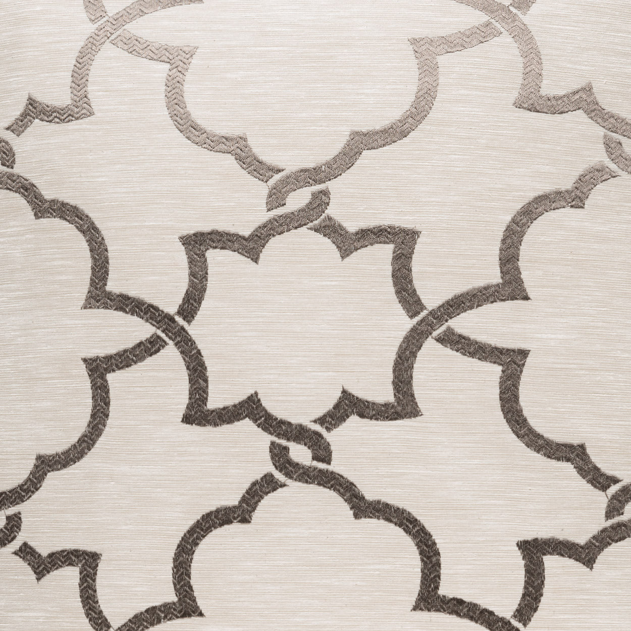 Beige fabric with taupe quatrefoil lattice pattern; textured textile for upholstery or drapery.