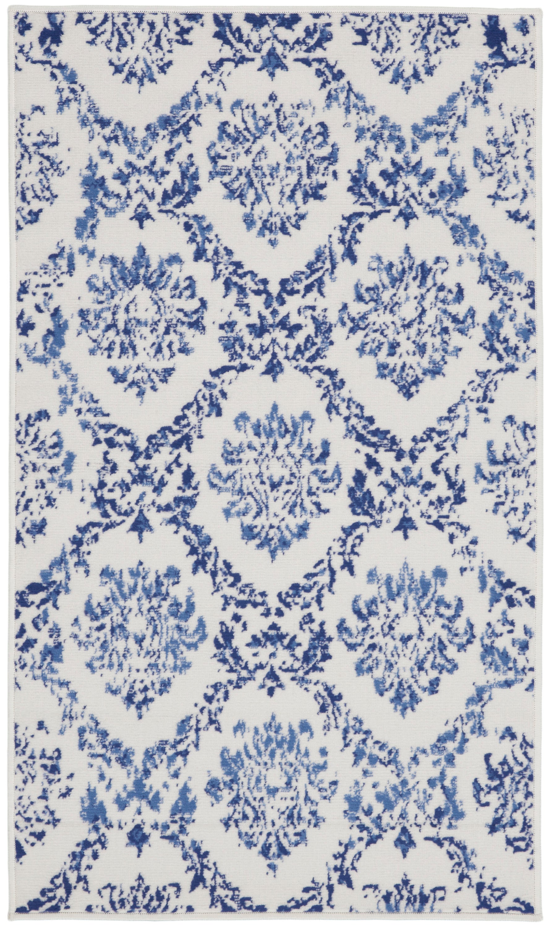 Blue damask-on-white area rug with repeated floral medallions; traditional decorative rug.