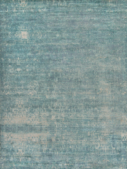 Teal distressed indoor hand loomed rug with vintage washed texture in blue-green tones; 6' x 9'.