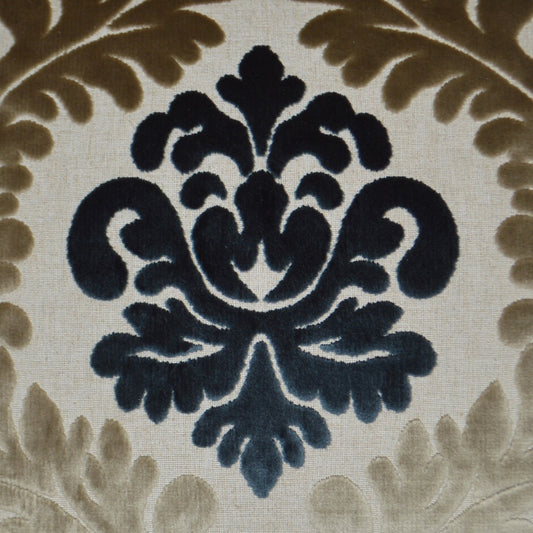 Dark navy damask floral motif on beige fabric with taupe scrolling border; classic upholstery textile.