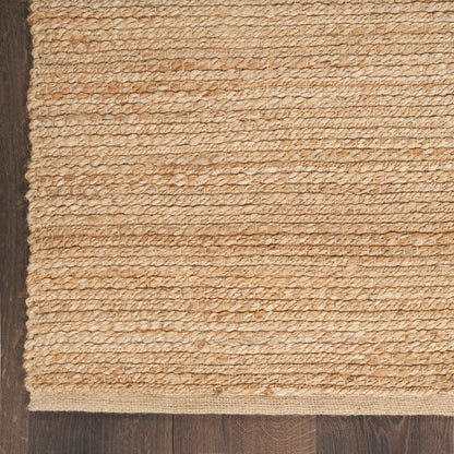 Beige gradient backdrop with a narrow vertical strip of natural jute rug along a dark wooden left edge.