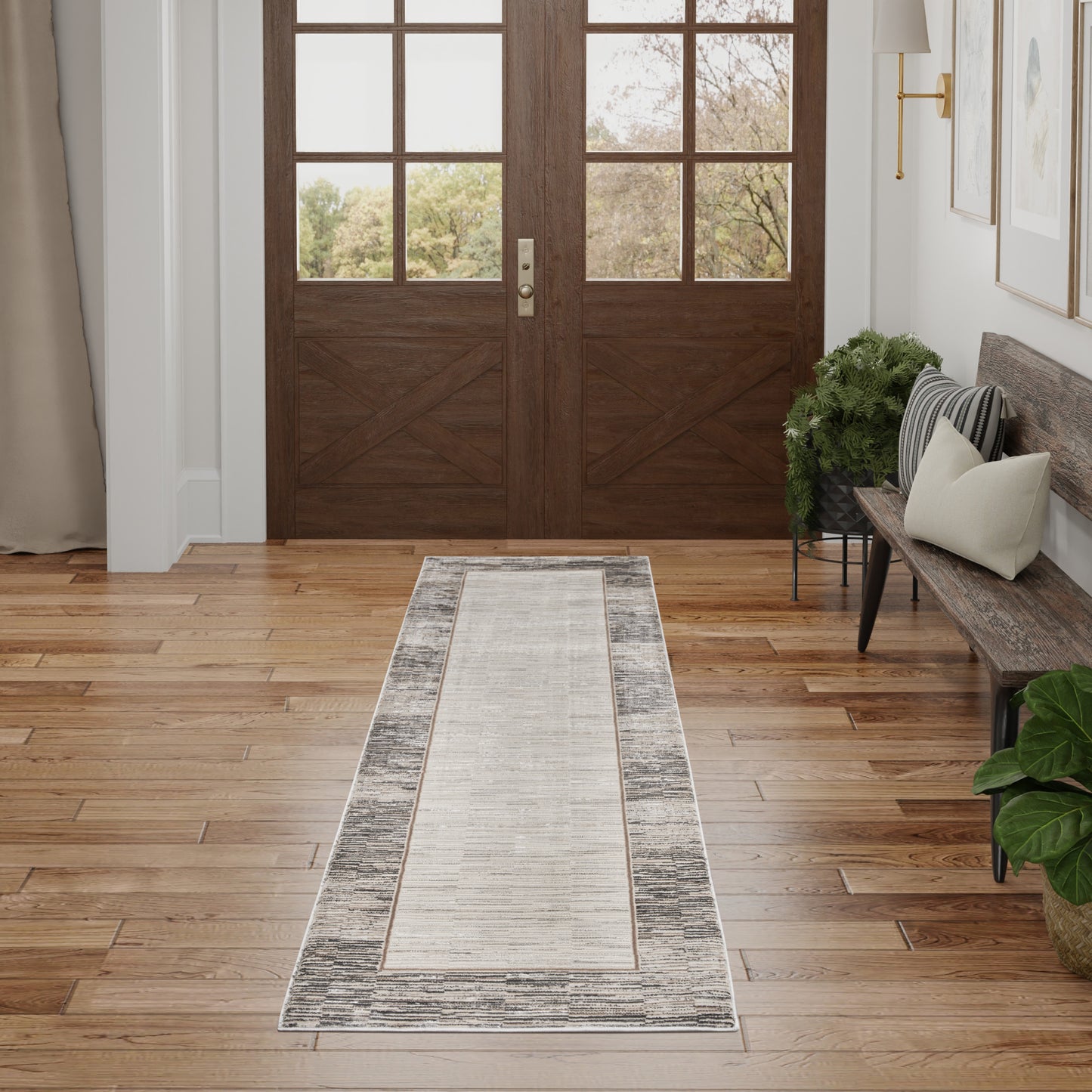 Entryway with dark wood double doors and grid windows; beige-gray runner rug with a bordered distressed pattern on hardwood floor.