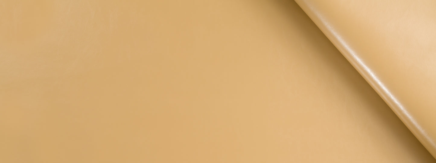 Tan leather texture with a diagonal seam and curved edge; smooth, premium upholstery leather.