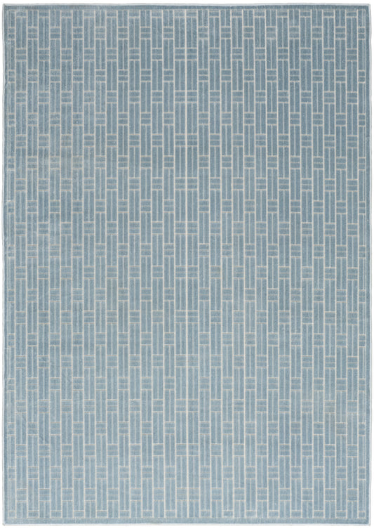 Blue-gray woven rug with a pale vertical geometric lattice pattern and subtle border.