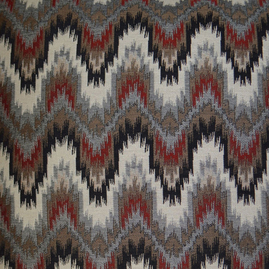 Multi-color zigzag ikat fabric in gray, charcoal, red & brown tones; woven chevron pattern for upholstery or decor.