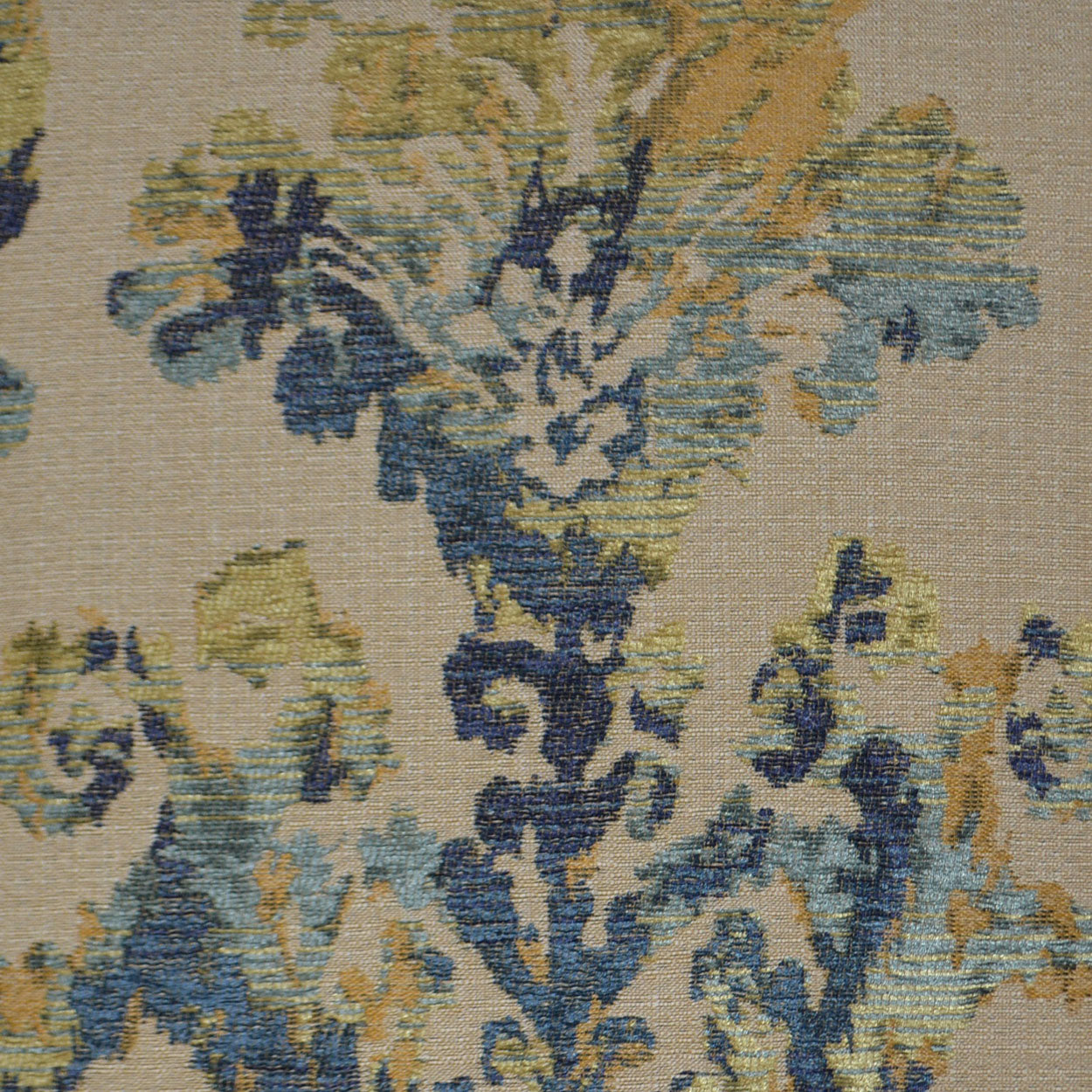 Beige woven fabric pillow with blue, teal and gold damask floral pattern; vintage textile.