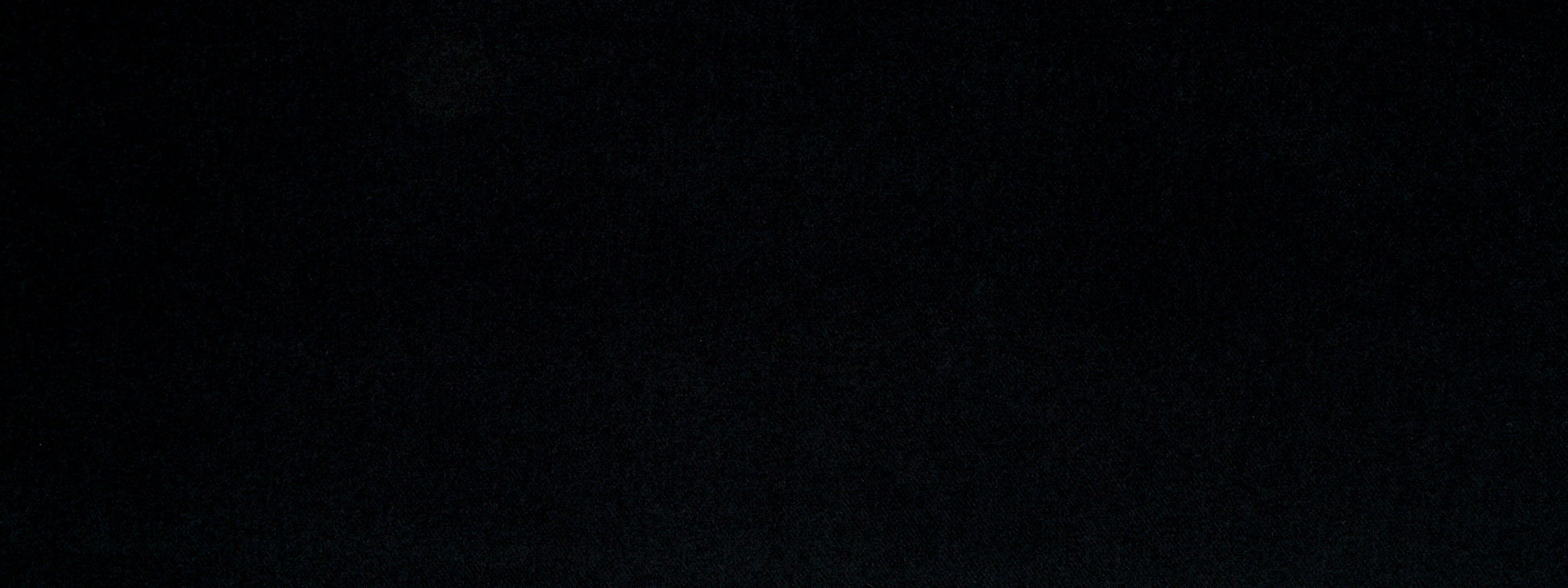 Solid black upholstery fabric with faint texture and subtle shading; minimal, versatile material.