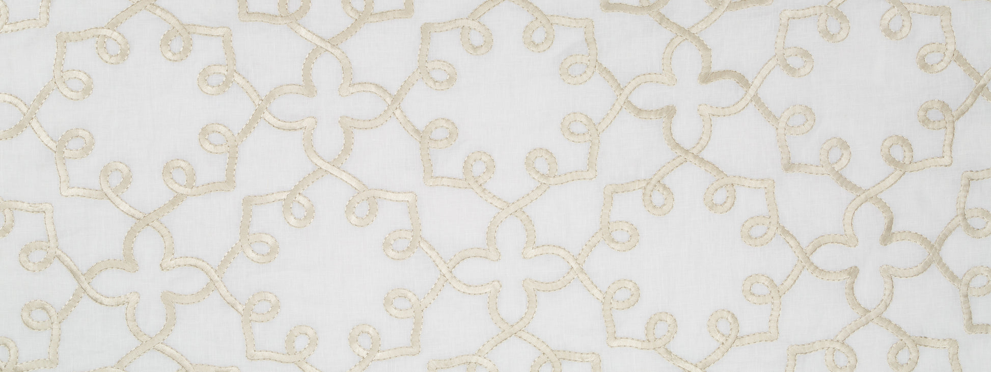 Cream embroidered looping pattern on white fabric; linen-like textile suitable for curtains or table runner.