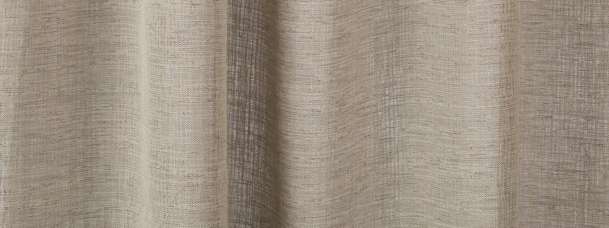 Beige linen-textured curtain fabric with soft vertical folds for neutral home decor.