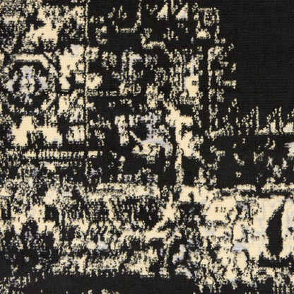 Black and cream distressed damask-inspired rug pattern, close-up woven textile texture.