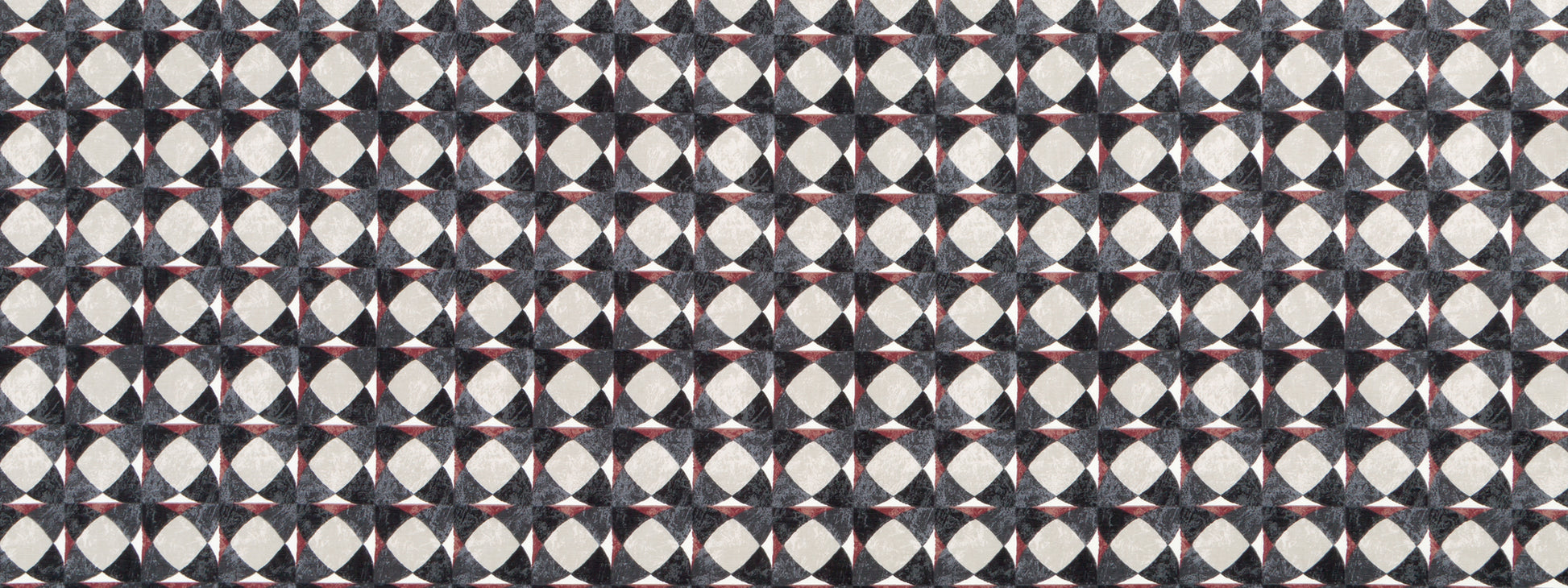 Geometric tessellated pattern in graphite with circular motifs repeating on a dark background.