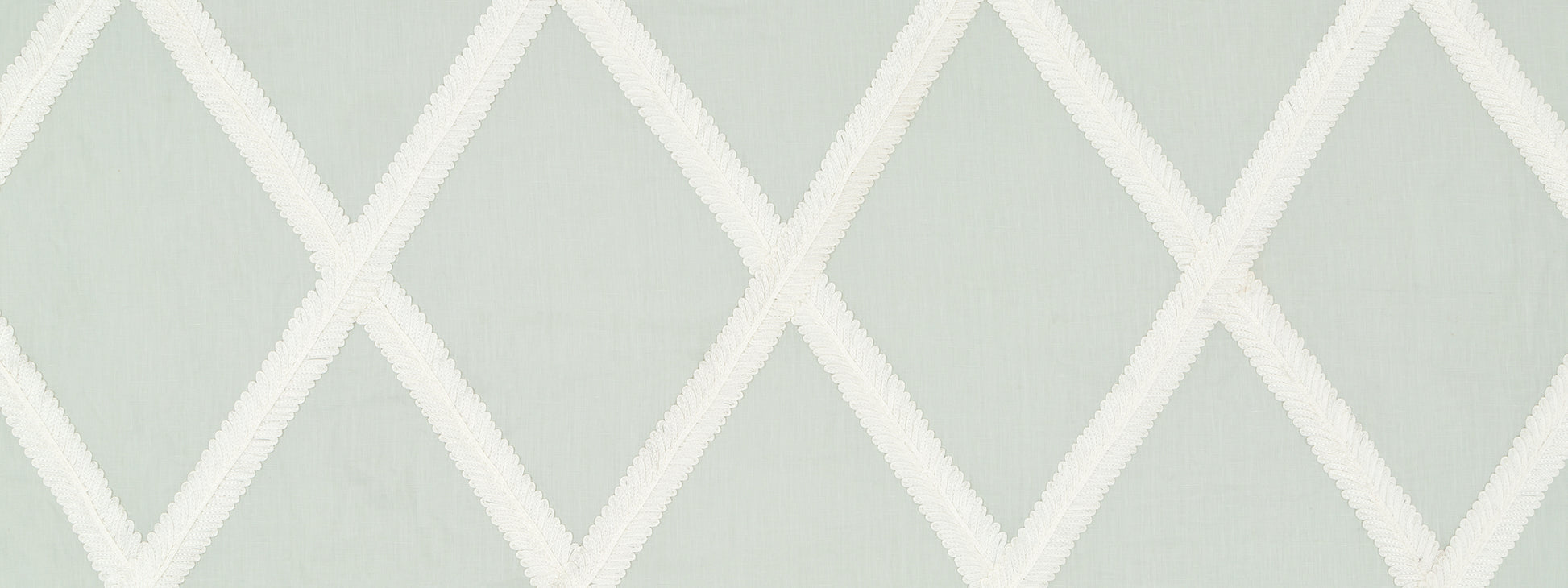 Soft sage green wallpaper with a white diamond lattice geometric pattern.