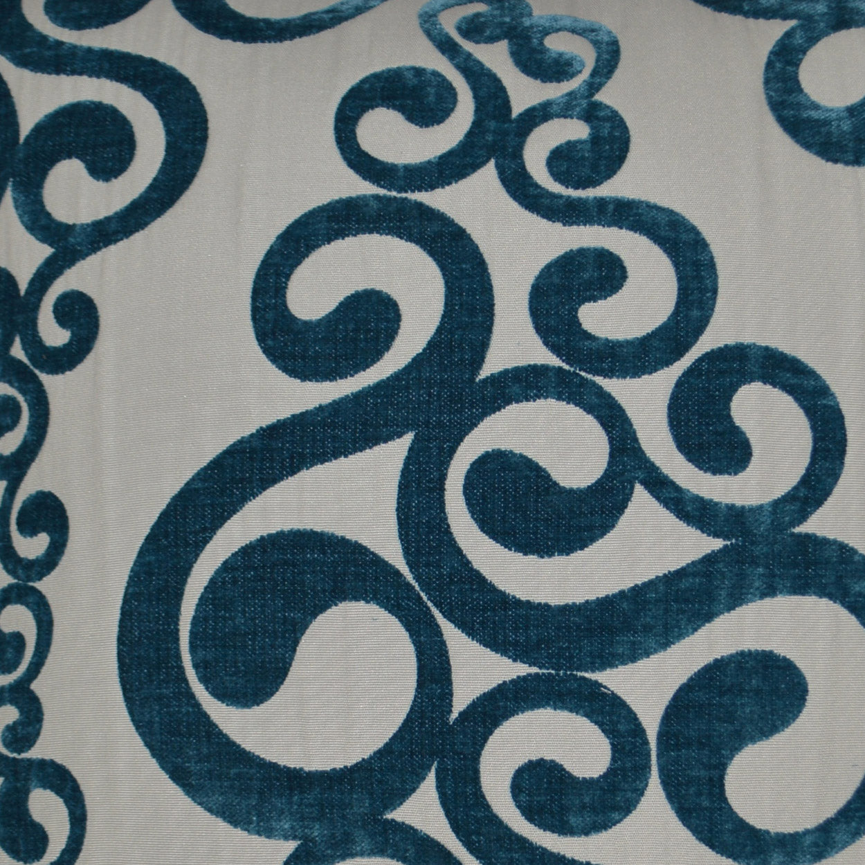 Teal blue swirling scroll damask pattern on ivory background; decorative 24x24 pillow.