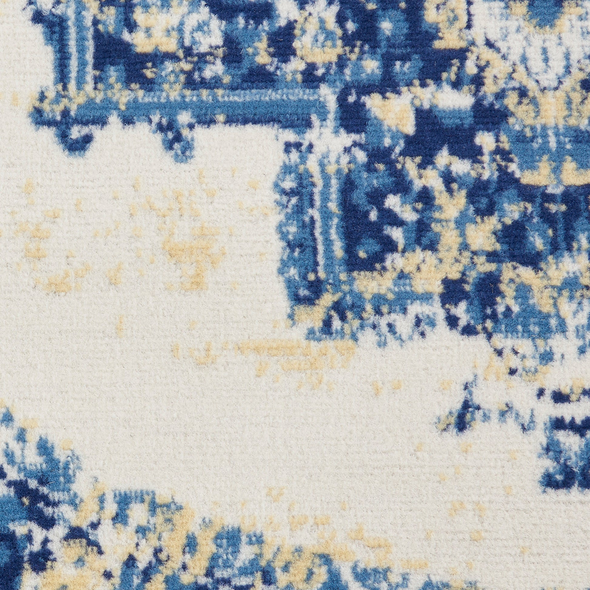 Abstract blue & beige rug with navy & light tan brush-stroke patterns on ivory background.