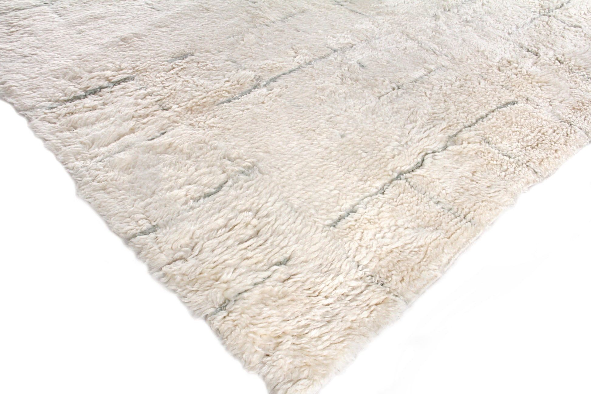 Cream rectangular Moroccan hand-knotted rug with subtle gray veining; soft, inviting texture for living room or bedroom.
