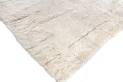 Cream rectangular Moroccan hand-knotted rug with subtle gray veining; soft, inviting texture for living room or bedroom.