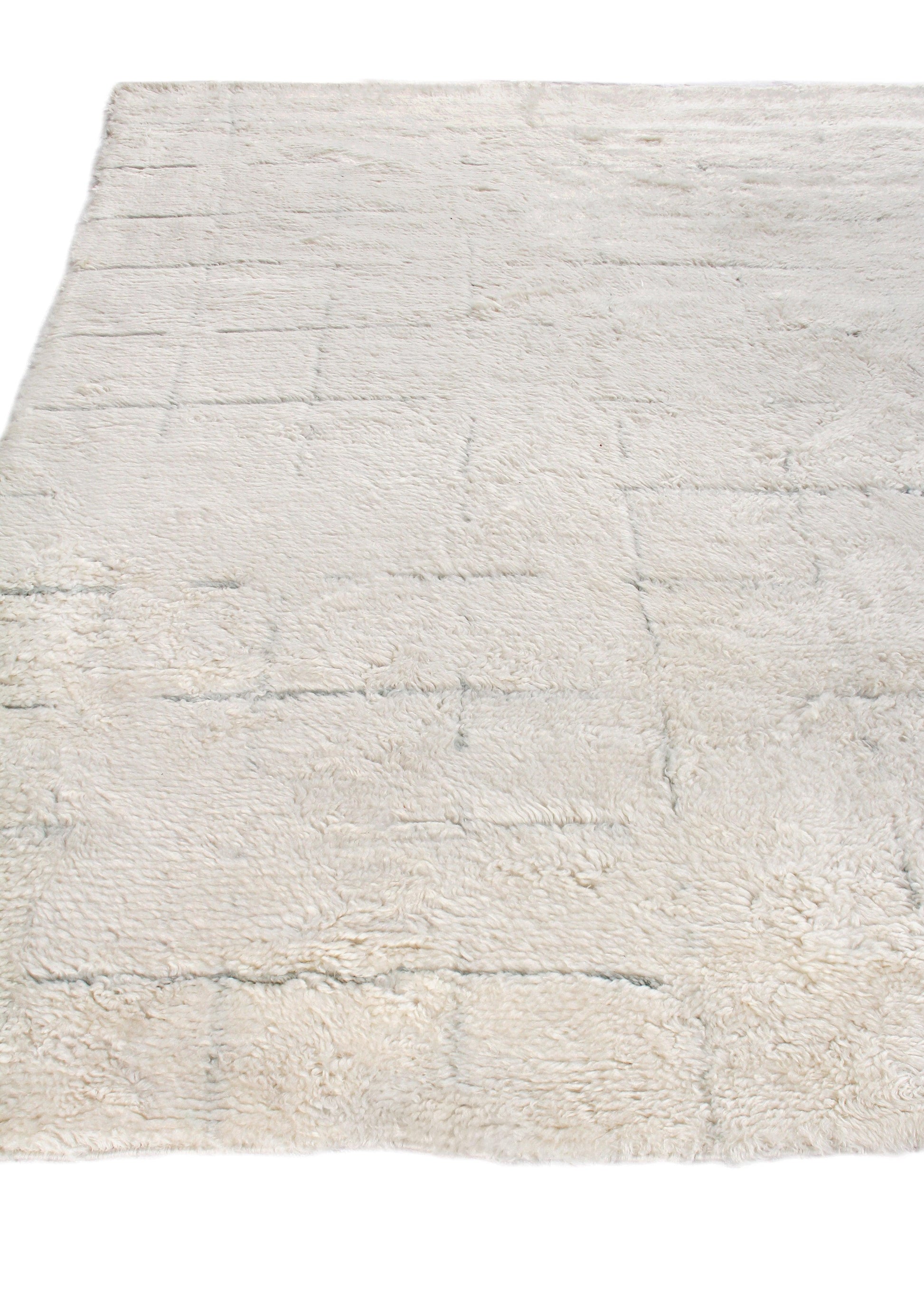 Cream Moroccan indoor hand-knotted rug, 6' x 9', with a subtle geometric pattern and textured pile.