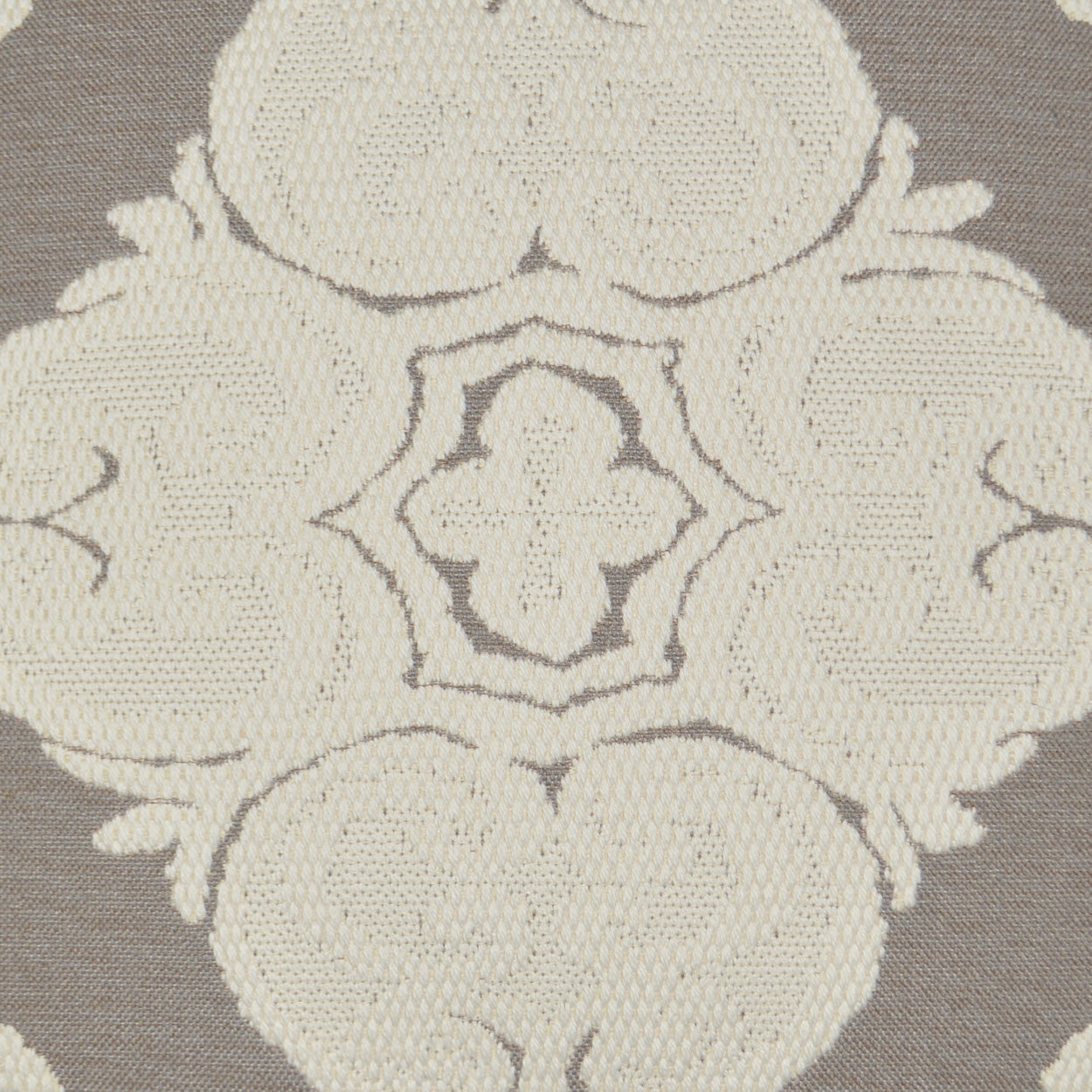 Cream embroidered damask medallion on taupe fabric; ornate floral pattern, textured textile for upholstery or curtains.