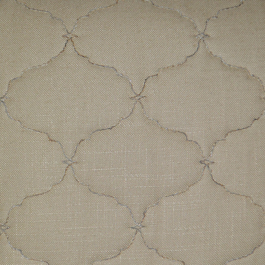 Beige fabric with subtle stitched quatrefoil motif in cream thread; quilted, textured home textile.