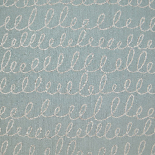 Light blue cotton fabric with repeated white looping cursive embroidery lines.