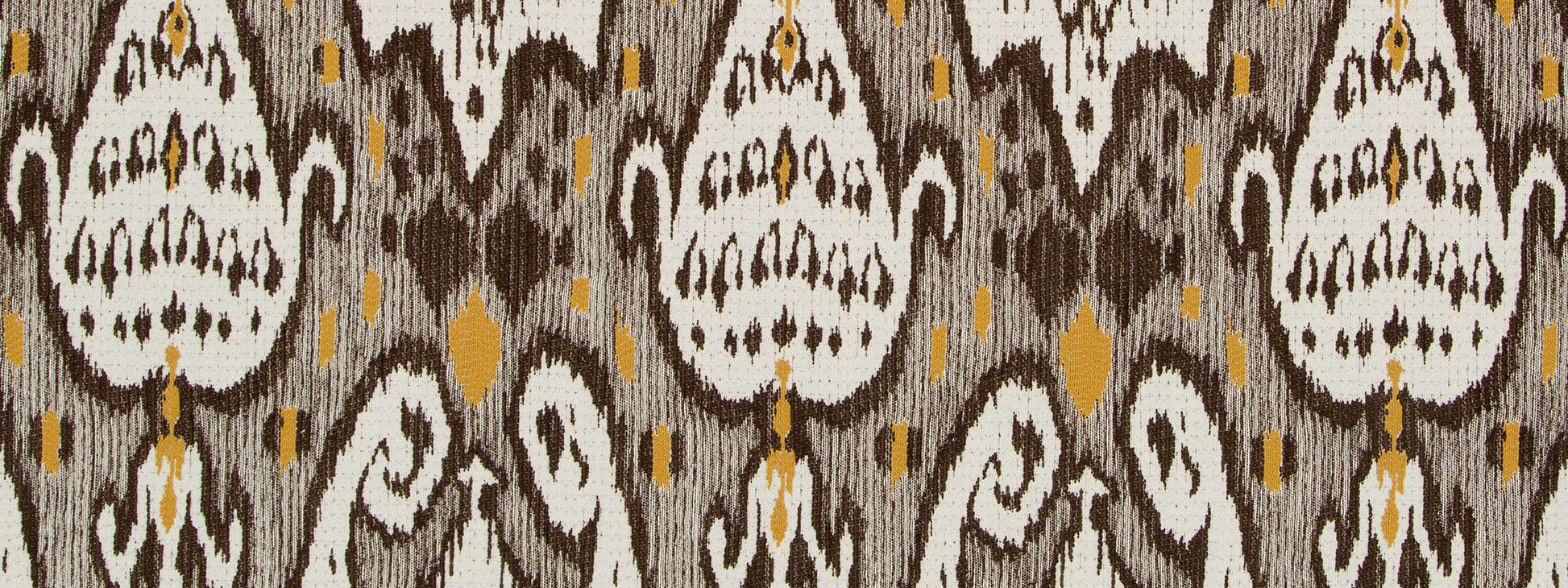 Ikat-inspired upholstery fabric in carob brown, ivory and gray with mustard accents; repeating teardrop motifs.