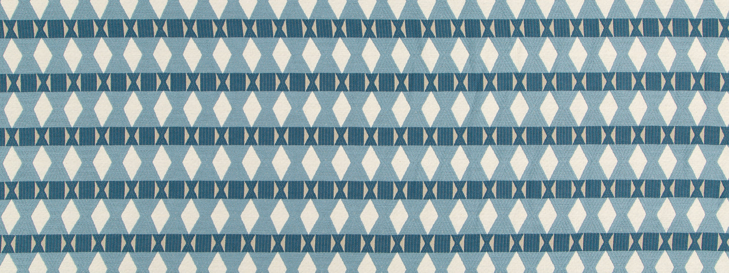 Blue geometric upholstery fabric with repeating diamond and triangle motifs in light and dark blues.