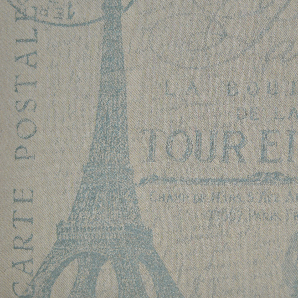 Beige fabric with blue Eiffel Tower silhouette and Paris text motif; vintage travel print for upholstery or crafts.